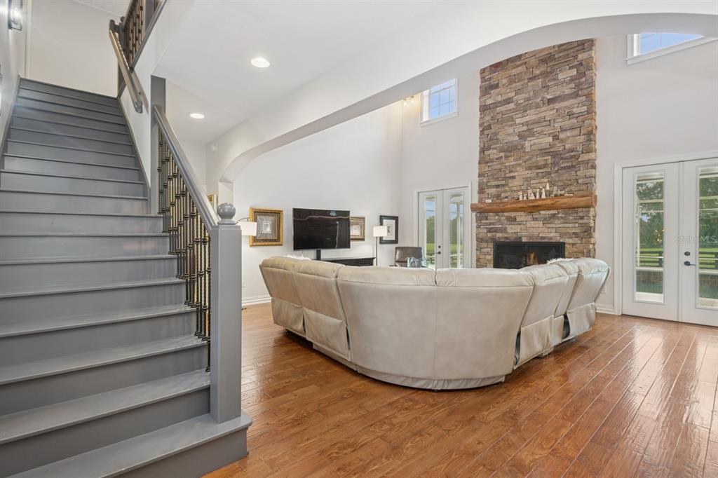 35520 Timbertop Lane Fruitland Park, FL 34731 - Photo 20 of 82 a living room with couches and a fireplace with wooden floor
