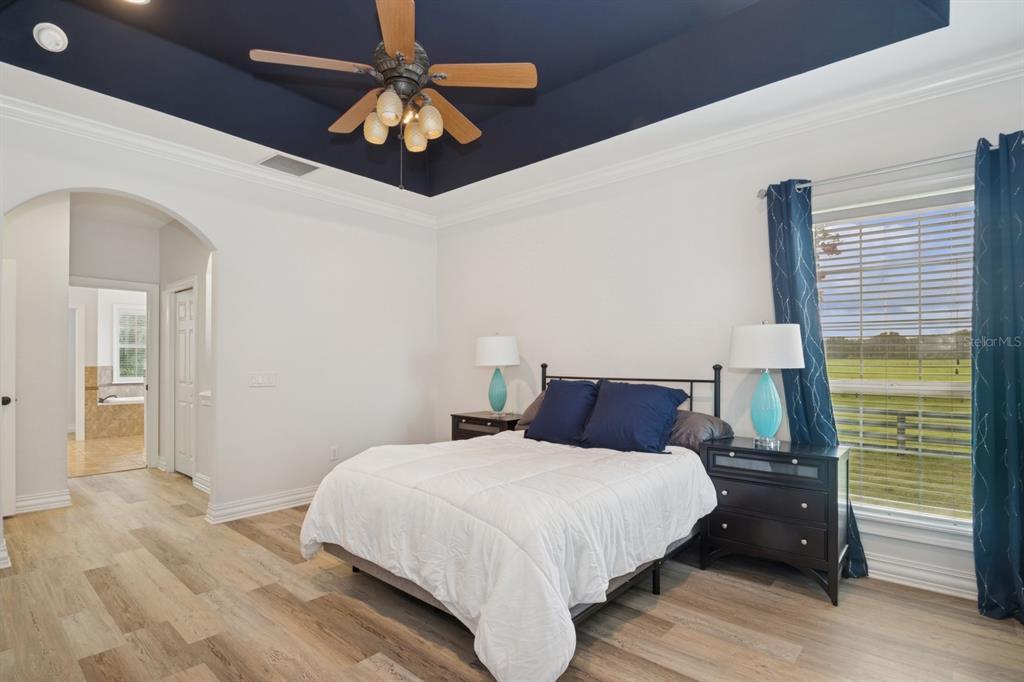 35520 Timbertop Lane Fruitland Park, FL 34731 - Photo 25 of 82 a bedroom with a bed chandelier and a window