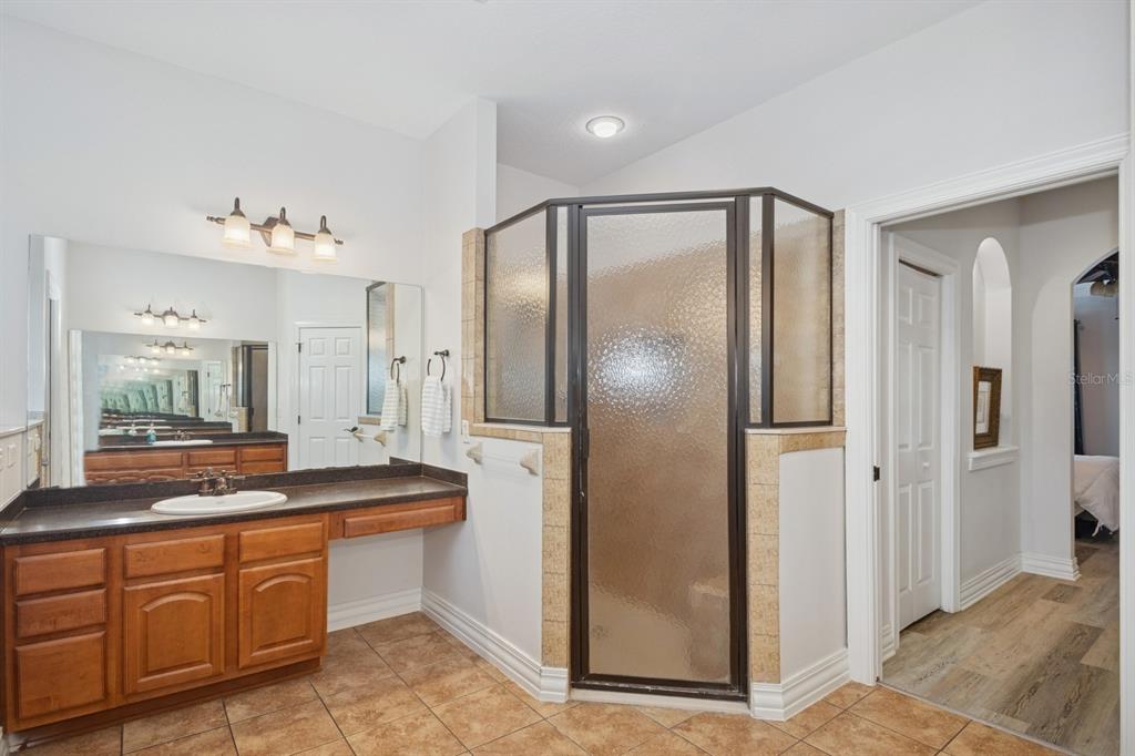 35520 Timbertop Lane Fruitland Park, FL 34731 - Photo 27 of 82 a spacious bathroom with a granite countertop sink mirror and refrigerator