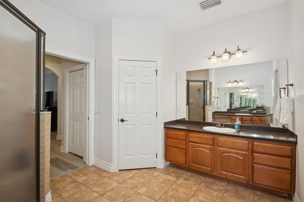 35520 Timbertop Lane Fruitland Park, FL 34731 - Photo 28 of 82 a spacious bathroom with a granite countertop sink and a mirror
