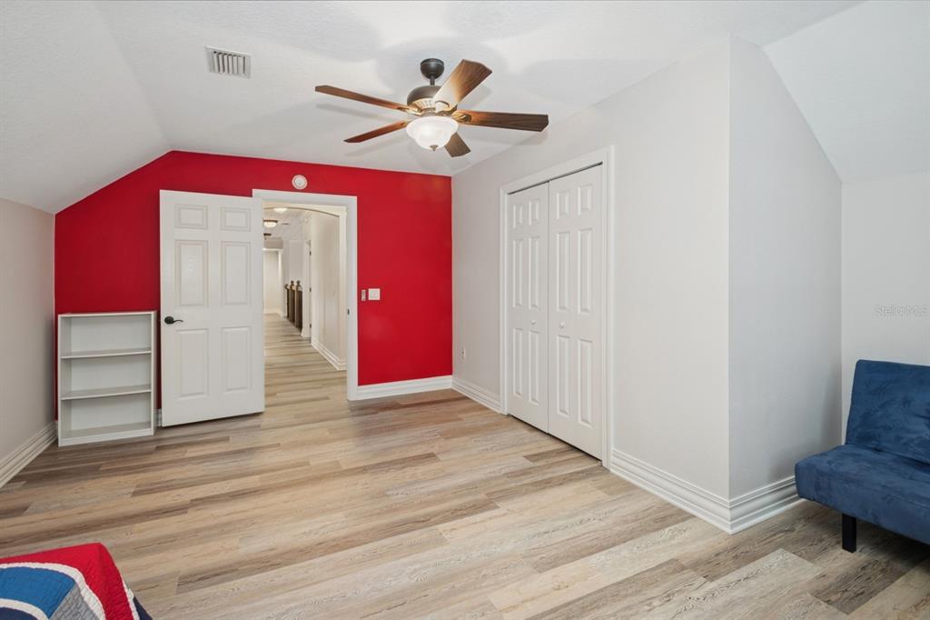 35520 Timbertop Lane Fruitland Park, FL 34731 - Photo 37 of 82 a view of a livingroom with wooden floor a ceiling fan and a kitchen