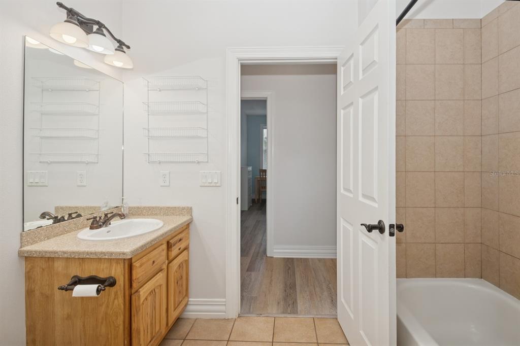 35520 Timbertop Lane Fruitland Park, FL 34731 - Photo 41 of 82 a bathroom with a sink a mirror and a bathtub