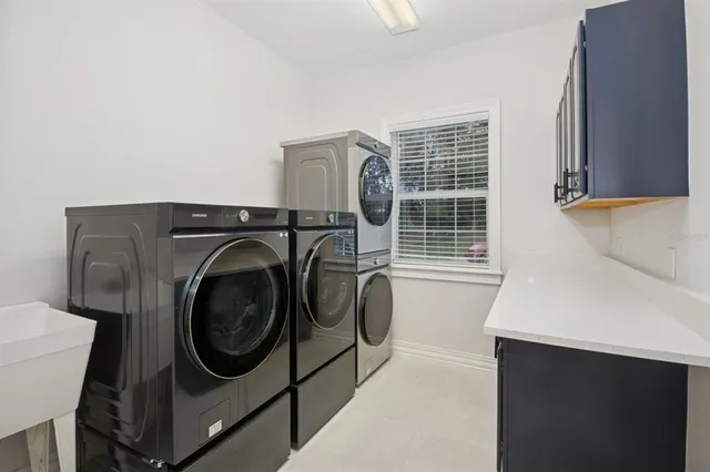 a room with pool table and windows