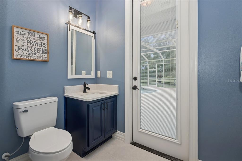 35520 Timbertop Lane Fruitland Park, FL 34731 - Photo 43 of 82 a bathroom with a toilet a sink and a mirror