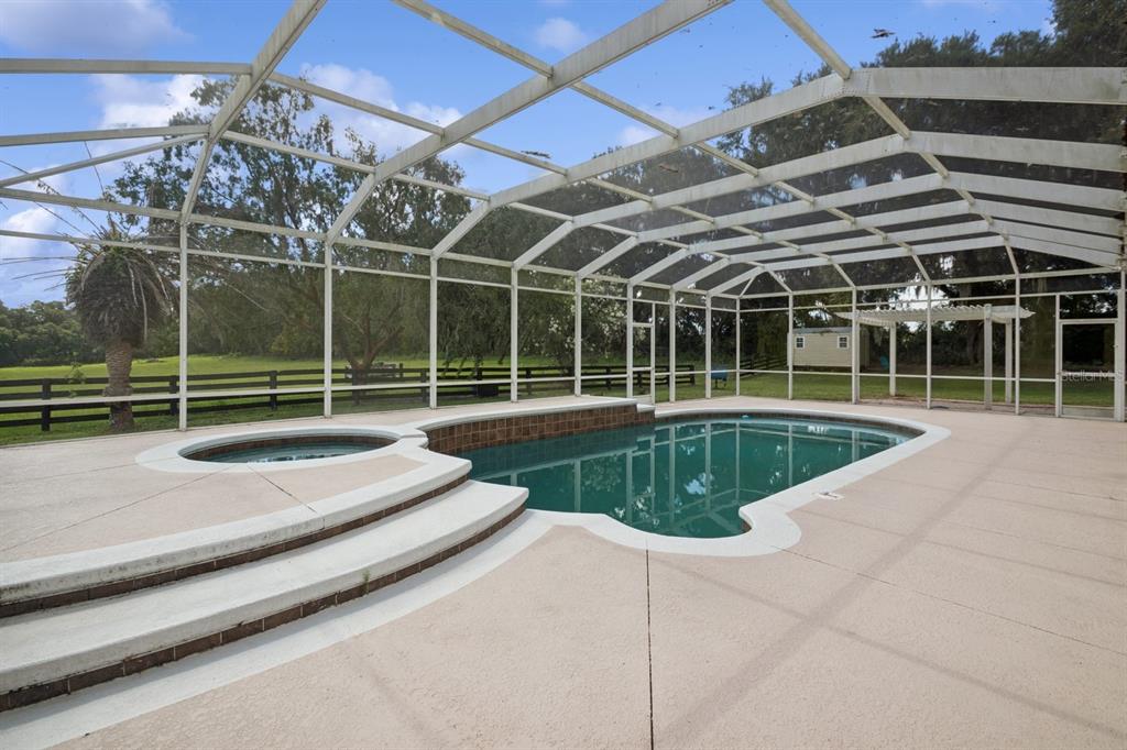 35520 Timbertop Lane Fruitland Park, FL 34731 - Photo 47 of 82 a view of a swimming pool with a wooden fence