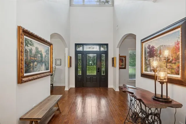 a living room with furniture a flat screen tv and wooden floor