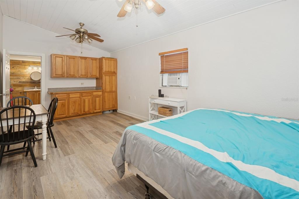 35520 Timbertop Lane Fruitland Park, FL 34731 - Photo 62 of 82 a bedroom with a bed and a chandelier