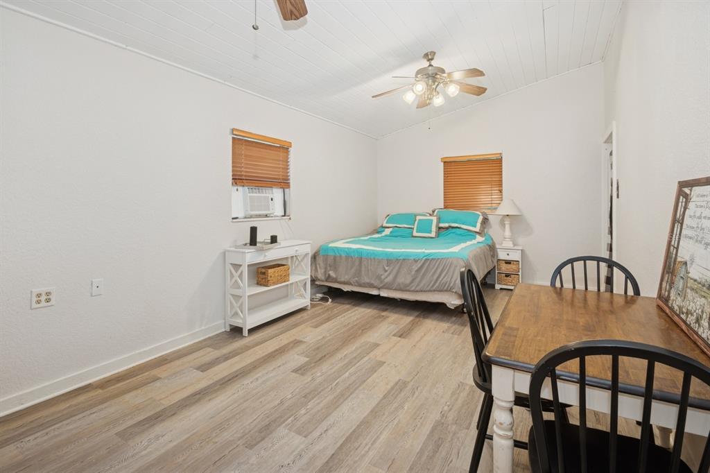 35520 Timbertop Lane Fruitland Park, FL 34731 - Photo 64 of 82 a bedroom with bed and a chandelier