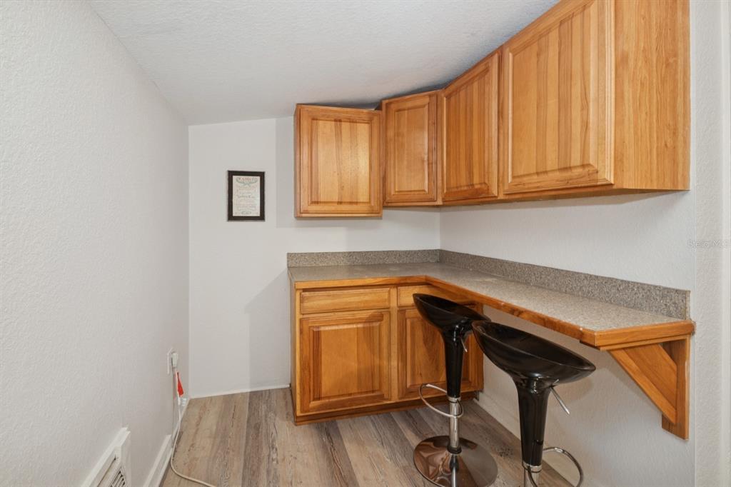 35520 Timbertop Lane Fruitland Park, FL 34731 - Photo 67 of 82 a kitchen with a sink a microwave cabinets and wooden floor