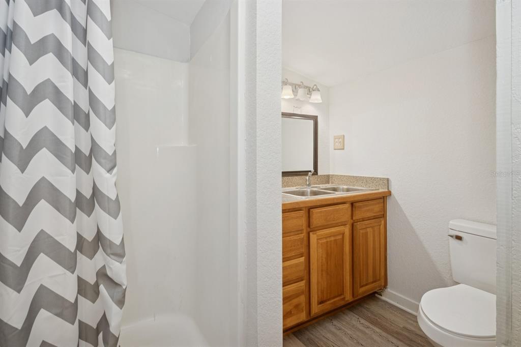 35520 Timbertop Lane Fruitland Park, FL 34731 - Photo 68 of 82 a bathroom with a granite countertop sink toilet and shower