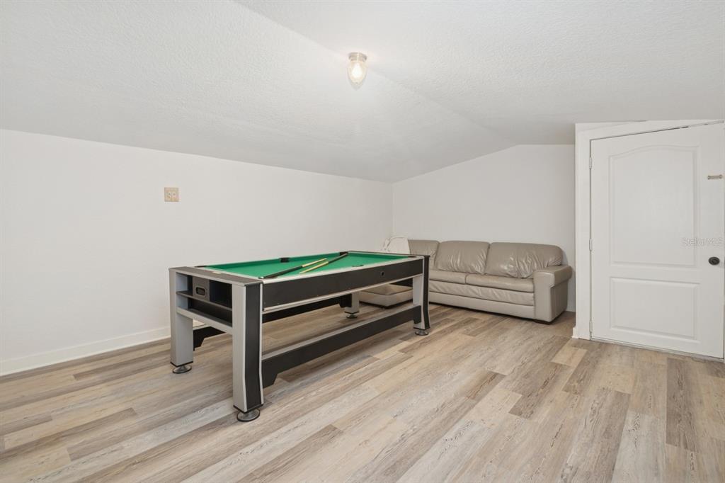 35520 Timbertop Lane Fruitland Park, FL 34731 - Photo 70 of 82 a living room with a bed and a table