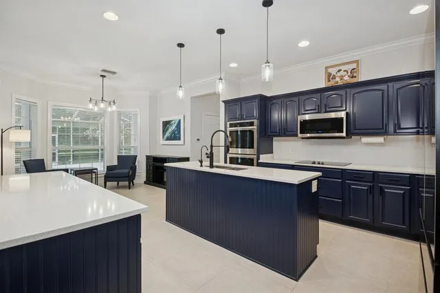 a kitchen with stainless steel appliances granite countertop wooden cabinets a refrigerator and a sink