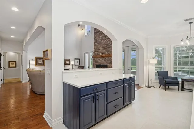 a kitchen with kitchen island a sink appliances and cabinets