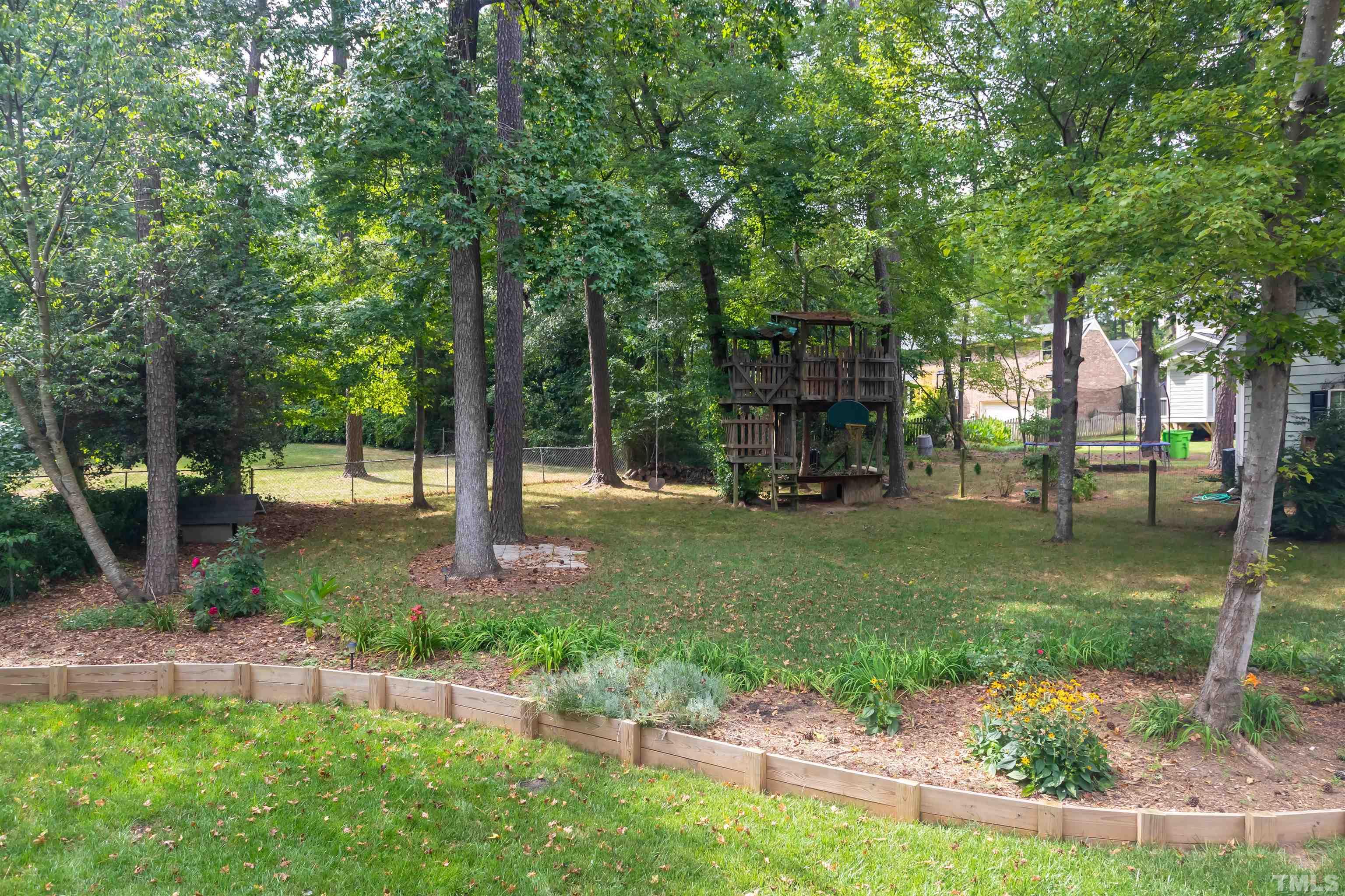 8217 Running Cedar Trail Raleigh, NC 27615 - Photo 4 of 23 a front view of a house with garden