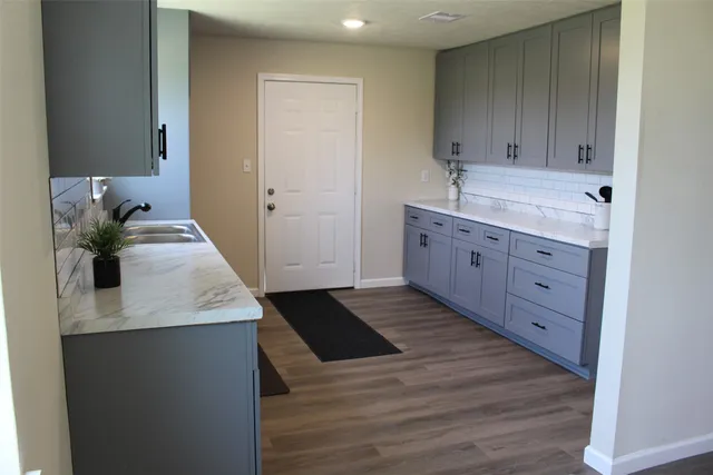a kitchen with a sink and cabinets