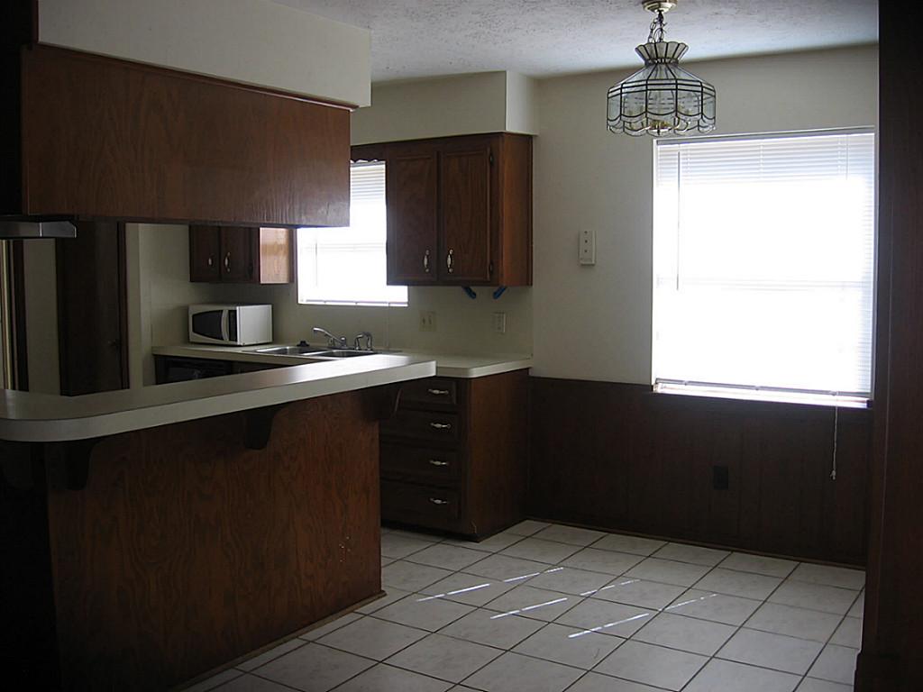 25407 Tuckahoe Lane Spring, TX 77373 - Photo 4 of 20 a kitchen with a sink a refrigerator and cabinets