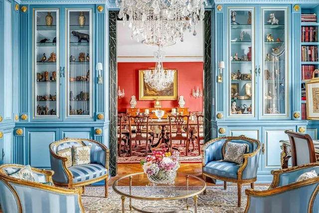 a dining room with furniture a chandelier and wooden floor