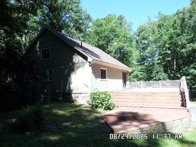 a backyard of a house with lots of green space and plants