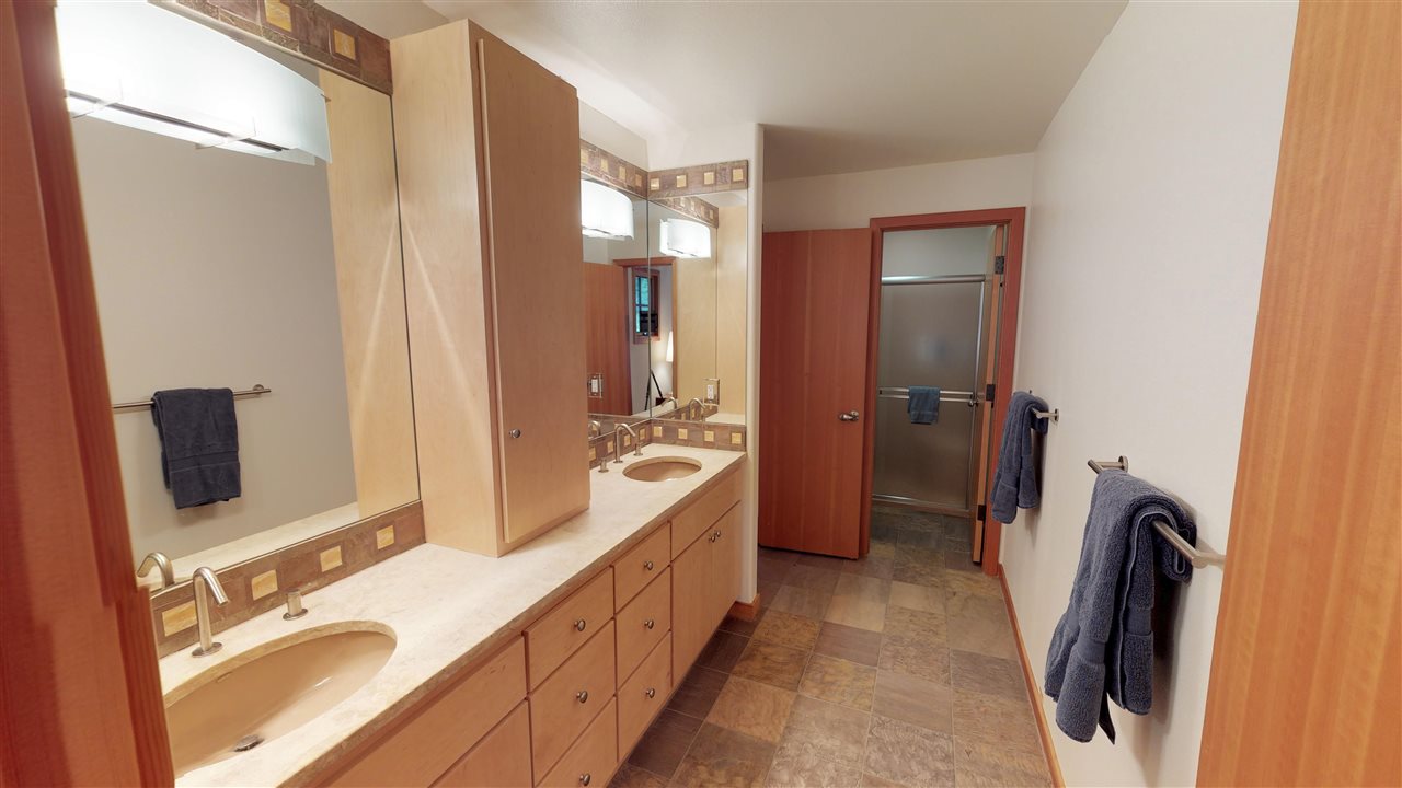 12998 Timber Ridge Road Truckee, CA 96161 - Photo 11 of 20 a spacious bathroom with a double vanity sink a mirror and shower