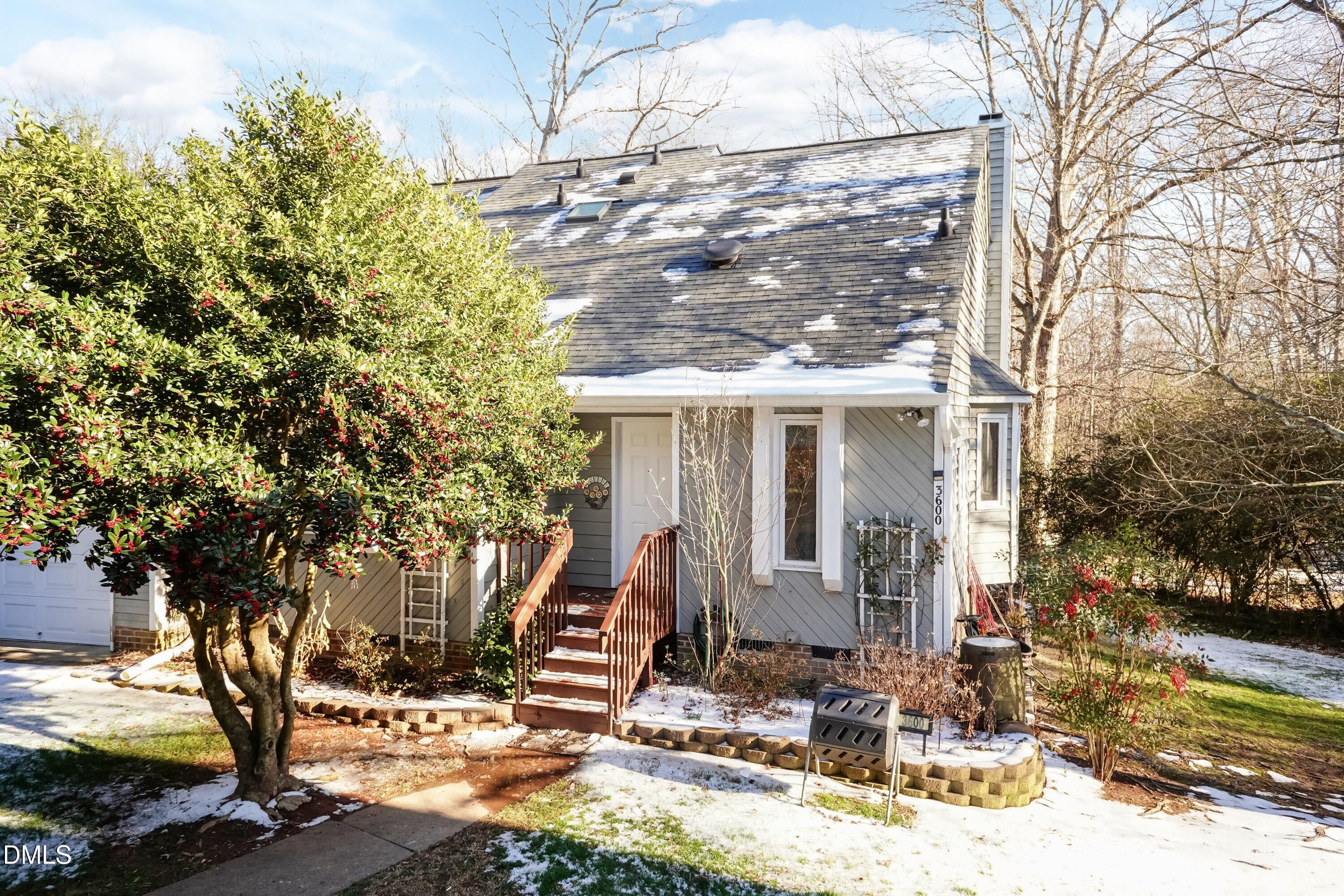 a view of house with a yard covered in snow