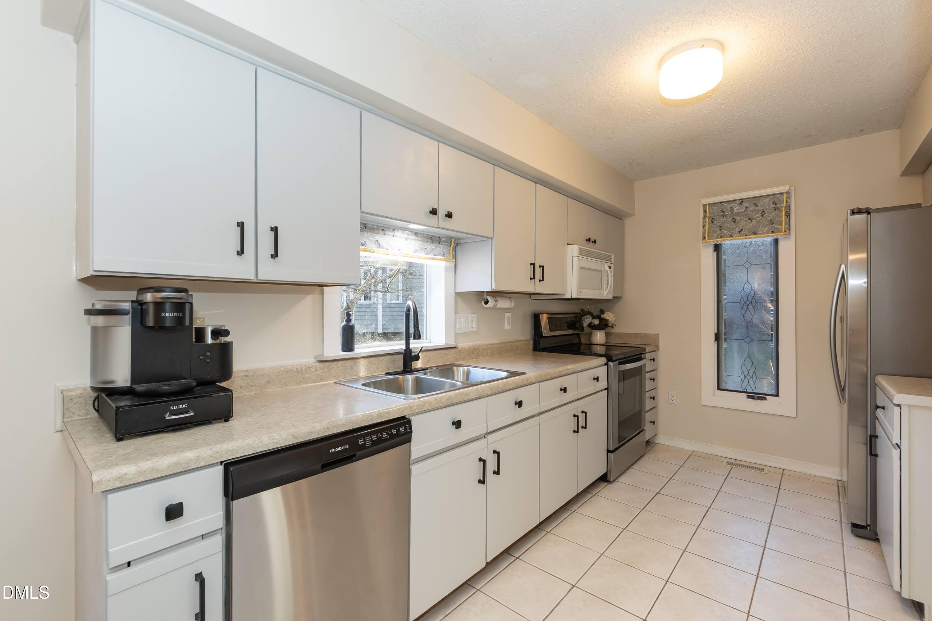 3600 Top Of The Pines Court Raleigh, NC 27604 - Photo 15 of 45 a kitchen with a sink stove and cabinets