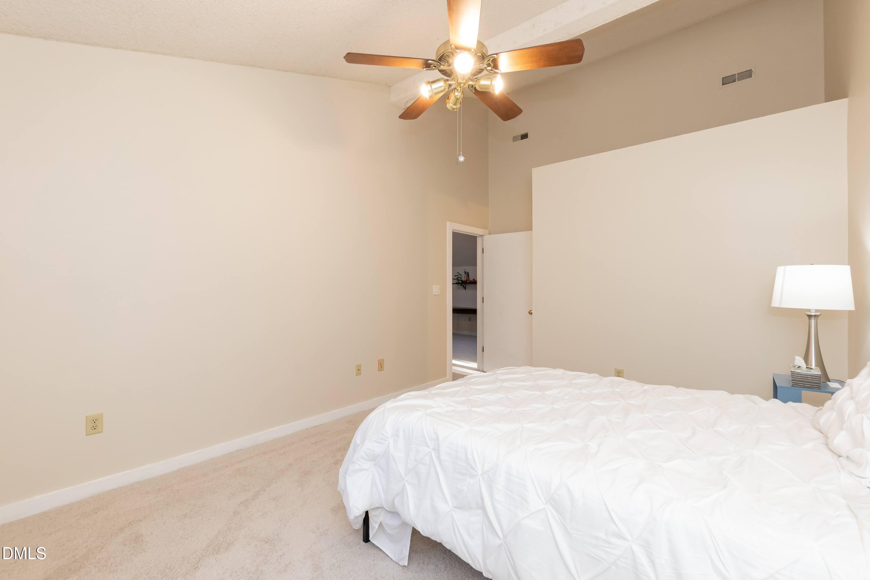 3600 Top Of The Pines Court Raleigh, NC 27604 - Photo 33 of 45 a bedroom with a bed and a lamp
