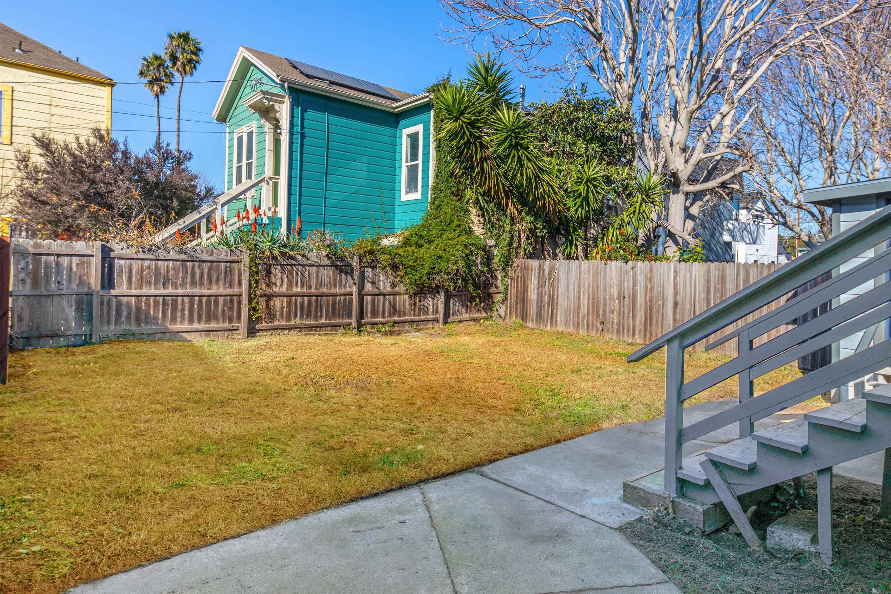 1111 Campbell Street Oakland, CA 94607 - Photo 16 of 17 a view of a backyard with a small cabin and wooden fence