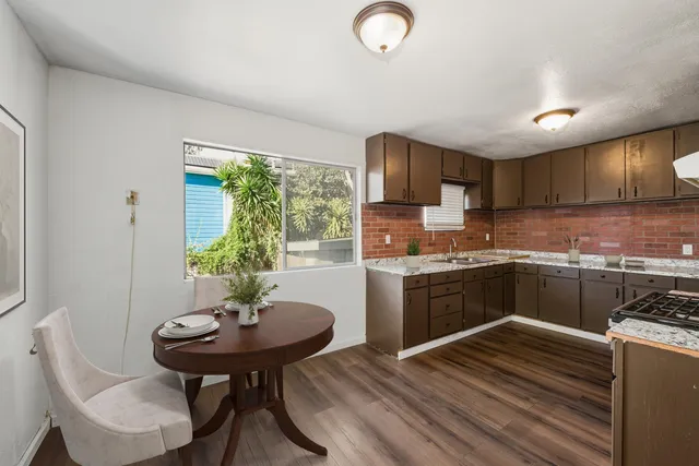 a kitchen with a sink cabinets and window