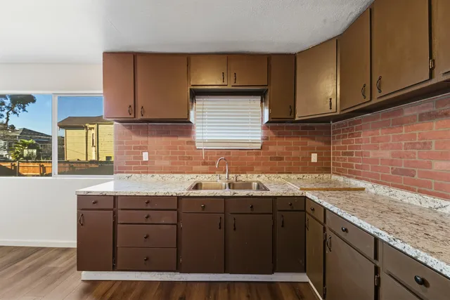 a kitchen with a sink a cabinets and window
