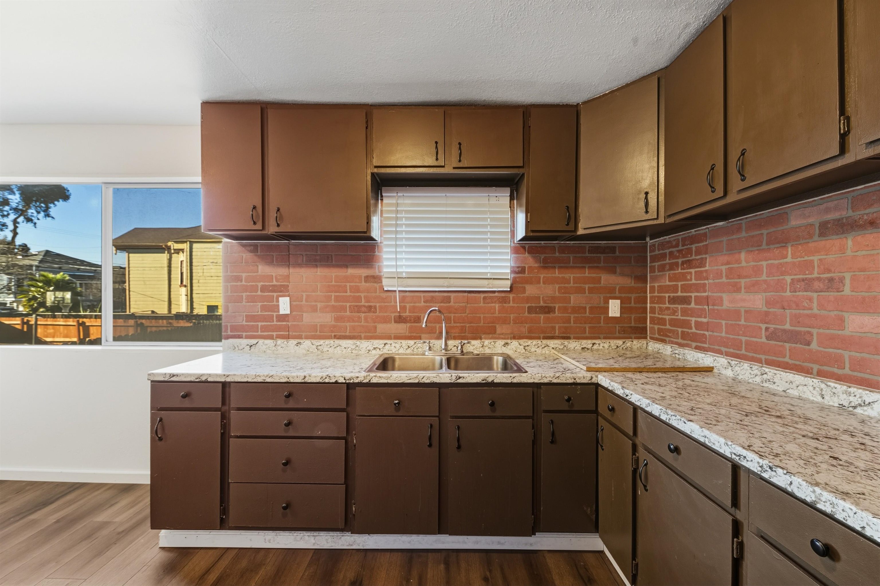 1111 Campbell Street Oakland, CA 94607 - Photo 8 of 17 a kitchen with a sink a cabinets and window