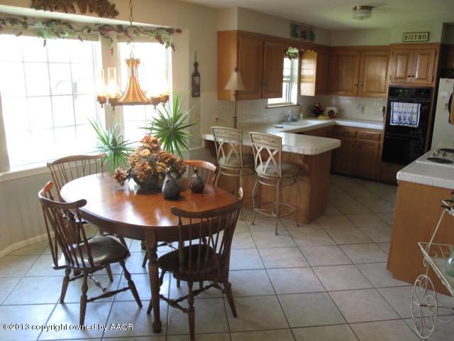 7106 Elmhurst Road Amarillo, TX 79106 - Photo 4 of 10 a view of a dining room with furniture and window