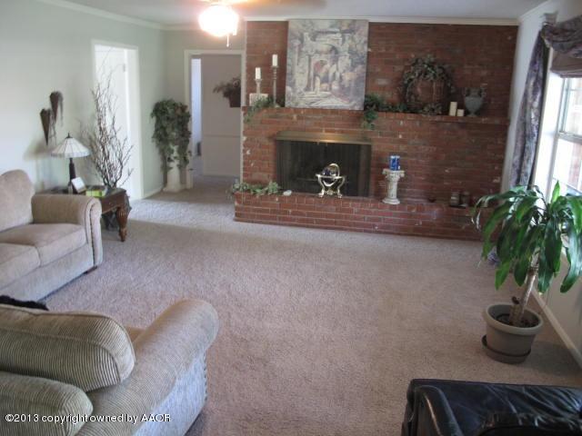 7106 Elmhurst Road Amarillo, TX 79106 - Photo 5 of 10 a living room with furniture and a fireplace