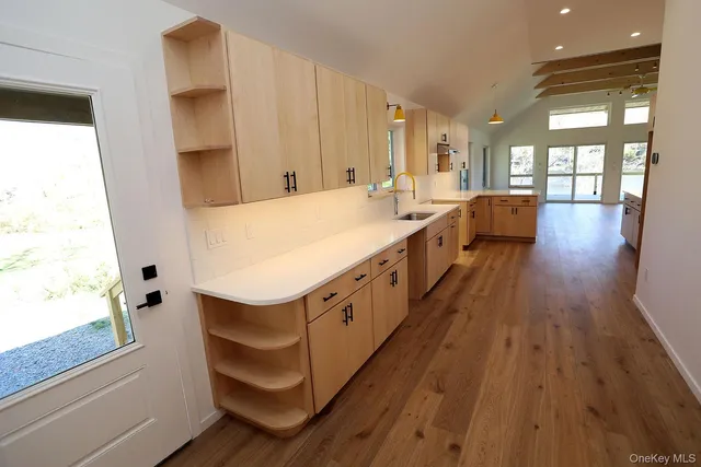 a large white kitchen with a large window