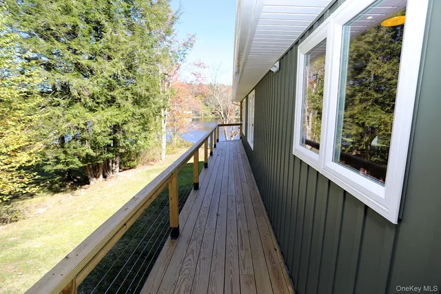 a view of balcony with wooden floor and fence