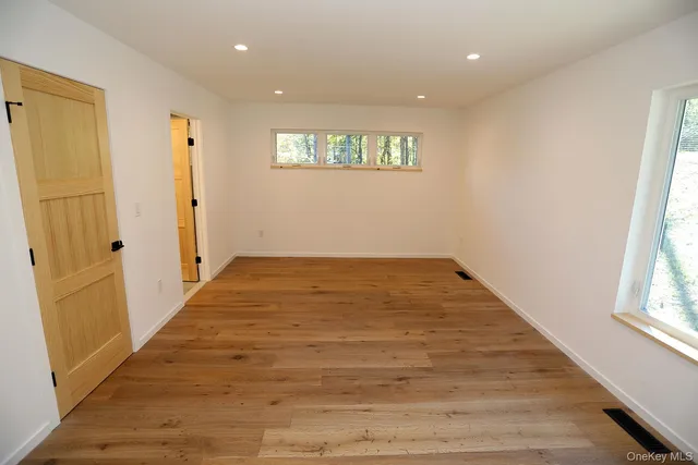 a view of an empty room and a window