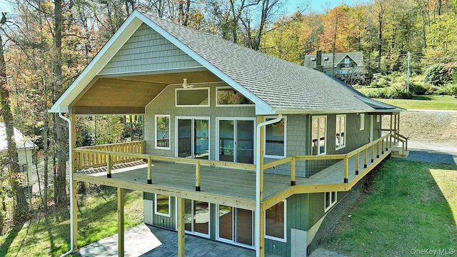 a view of house with a big yard and potted plants