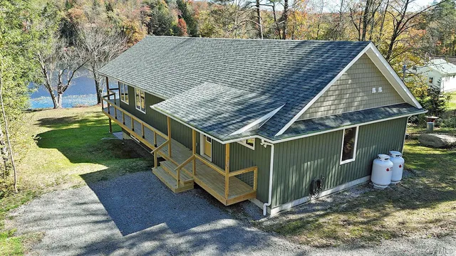 a view of a wooden house with a yard