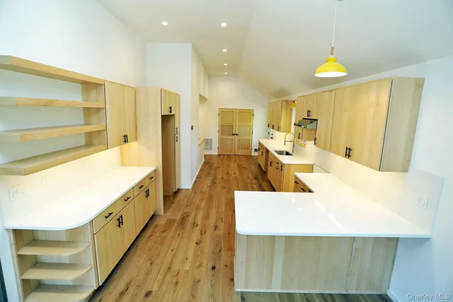 a large bathroom with mirror and a sink