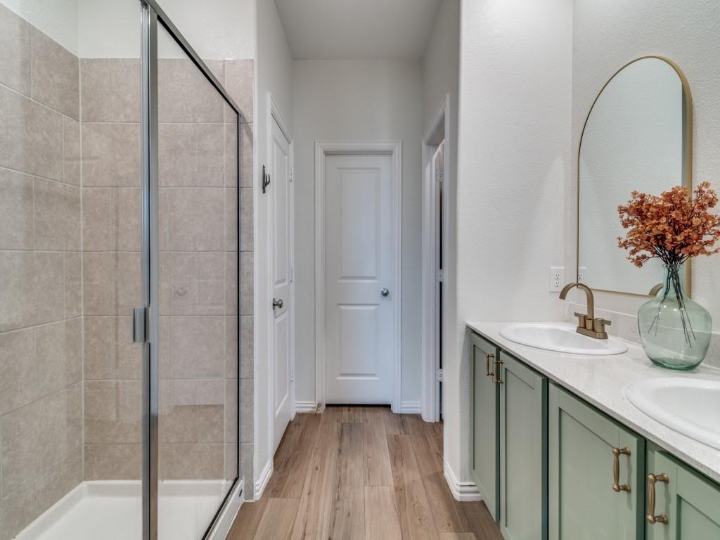 656 Beltrand Lane Fate, TX 75087 - Photo 10 of 22 LVP flooring, double vanity, and walk-in closet