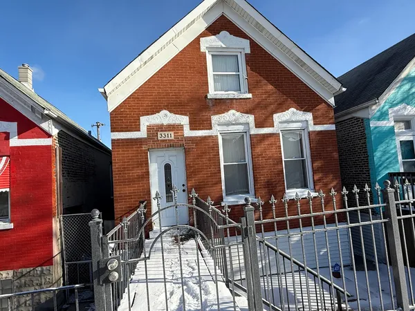 a view of a house with iron fence