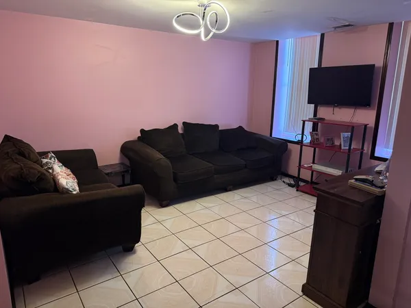 a living room with furniture and a flat screen tv