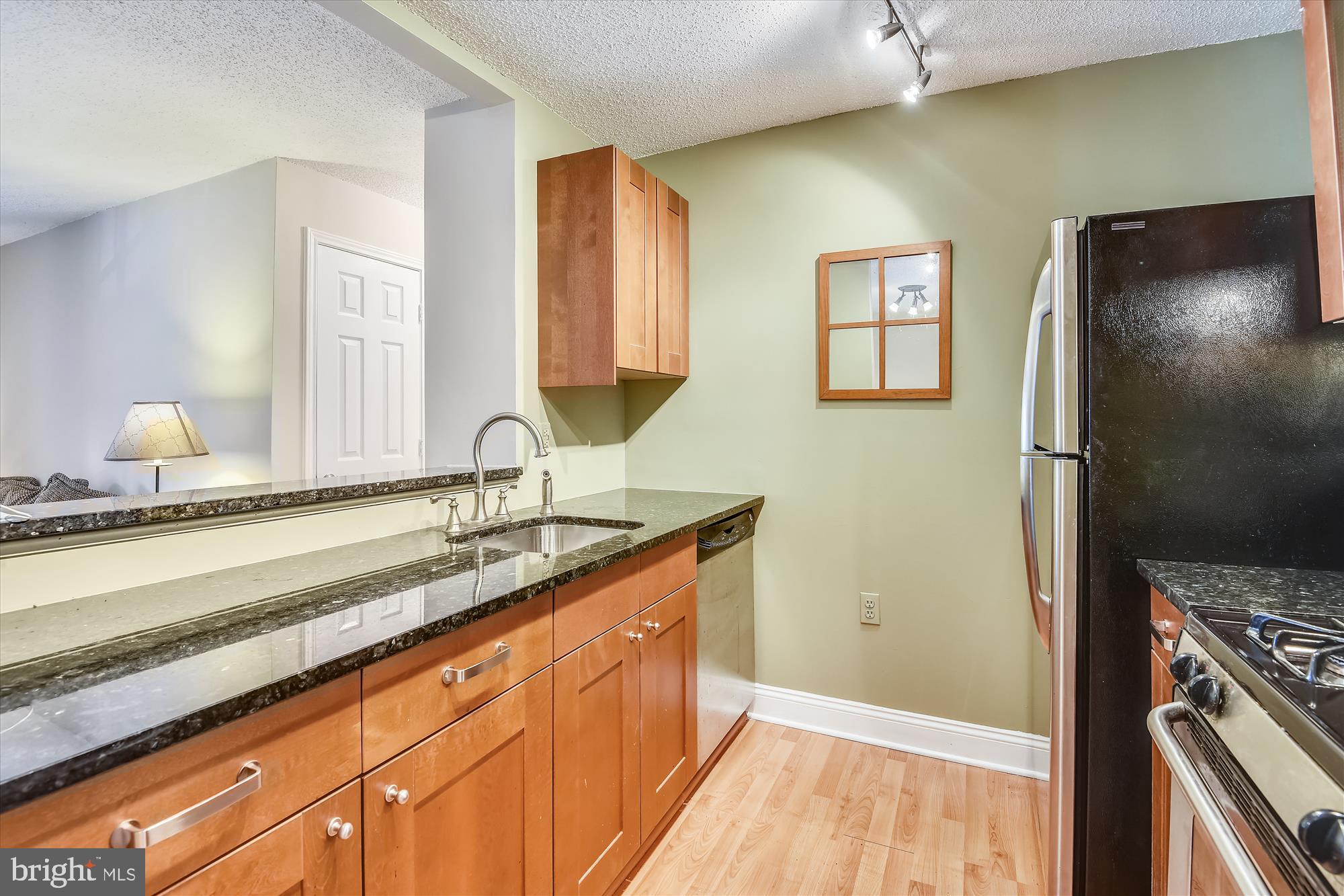 20979 Timber Ridge Terrace, Unit 204 Ashburn, VA 20147 - Photo 3 of 29 a bathroom with a sink and a mirror