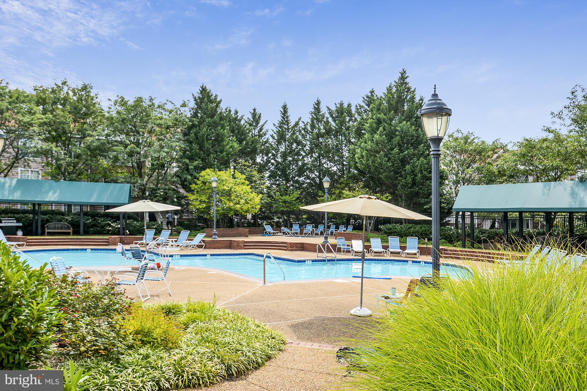 20979 Timber Ridge Terrace, Unit 204 Ashburn, VA 20147 - Photo 22 of 29 a swimming pool with outdoor seating and yard
