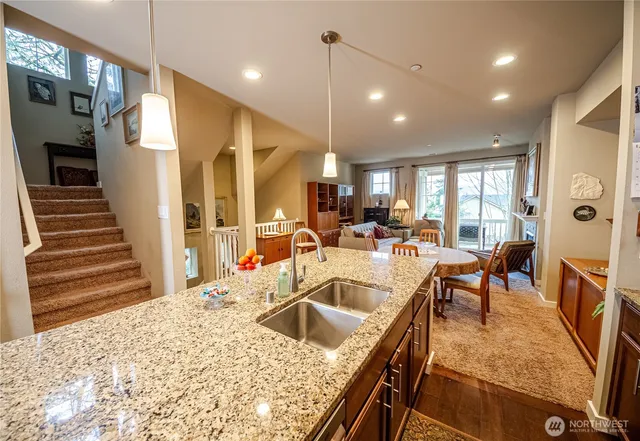 a kitchen with stainless steel appliances kitchen island granite countertop a sink and cabinets