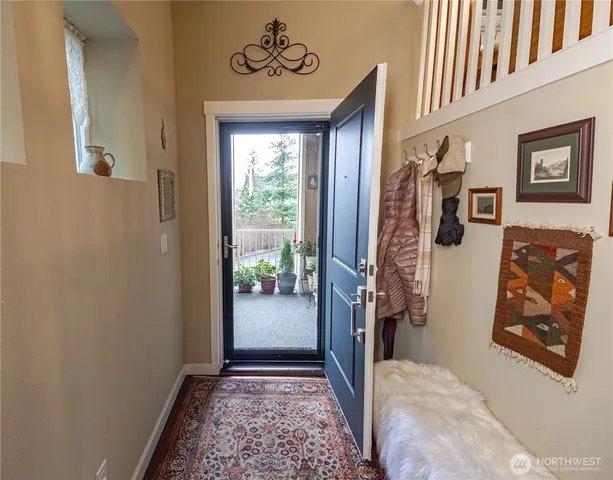 a view of an entryway with wooden floor