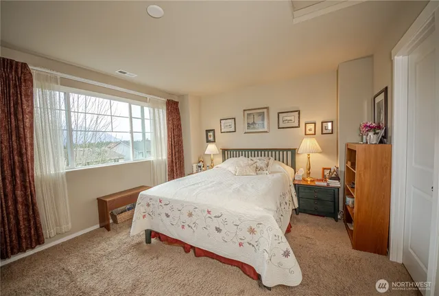 a bedroom with a bed and a window