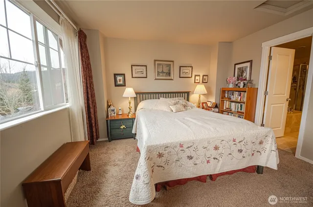 a bedroom with a large bed and a window