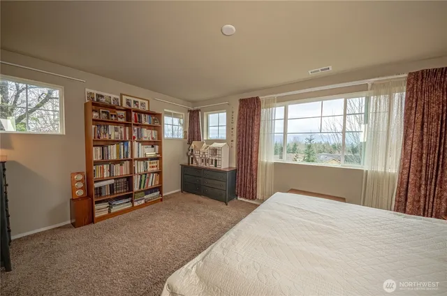 a spacious bedroom with a large bed and a window