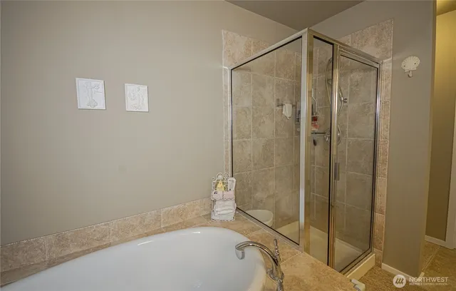 a bathroom with a bathtub and a shower