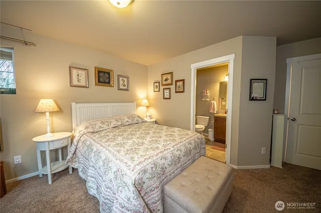 a bedroom with a bed and a lamp